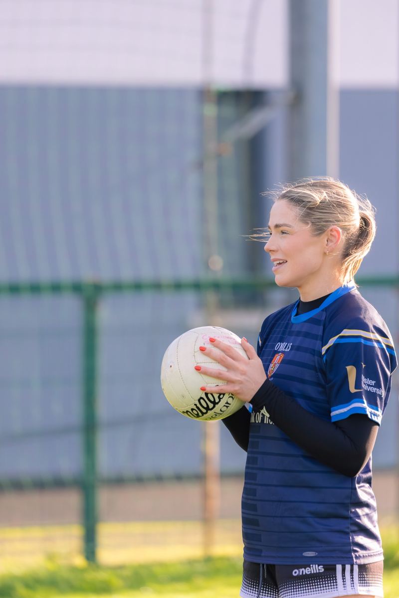 Coach holding a ball at training